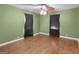 This cozy bedroom features hardwood floors, and ample natural light filtering through its two windows at 6393 Walker Rd, Riverdale, GA 30296