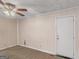 Carpeted bedroom featuring a ceiling fan and a back door for convenient access at 6393 Walker Rd, Riverdale, GA 30296