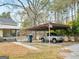 Covered carport features a truck and 'Beware of Dog' sign, providing convenient parking and added security at 6393 Walker Rd, Riverdale, GA 30296