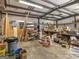 Garage with concrete floor, exposed metal beams, and abundant storage space at 6393 Walker Rd, Riverdale, GA 30296