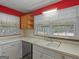 Functional kitchen with a double basin sink, ample counter space, and a window overlooking the backyard at 6393 Walker Rd, Riverdale, GA 30296