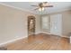 Living room with hardwood floors, neutral walls, ceiling fan and open kitchen access at 6393 Walker Rd, Riverdale, GA 30296