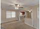 Inviting living room featuring an open layout, carpet flooring, and natural light streaming through the windows at 6393 Walker Rd, Riverdale, GA 30296