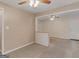 Living room with neutral paint, ceiling fan, and an open floor plan to the dining area at 6393 Walker Rd, Riverdale, GA 30296