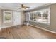 Living room features a large window, coat rack, hardwood flooring and neutral walls at 6393 Walker Rd, Riverdale, GA 30296