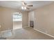 Cozy carpeted living room with lots of natural light and views to the kitchen at 6393 Walker Rd, Riverdale, GA 30296