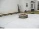 View of the backyard, featuring a stone fire pit, white siding, and privacy fence at 7564 Mountain Ridge Ln, Lithonia, GA 30058