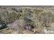 Aerial shot of a house with surrounding lush tree coverage and other houses nearby at 302 Cumberland Ct, Peachtree City, GA 30269