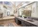 Spa-like bathroom with dual vanities, large mirrors, tile flooring and a glass-enclosed shower at 302 Cumberland Ct, Peachtree City, GA 30269