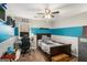 Bedroom with desk, gaming chair and dark wood bedframe and blue and white color scheme at 302 Cumberland Ct, Peachtree City, GA 30269