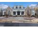 Stone and white facade with striking architectural details, including arched windows and dormers at 302 Cumberland Ct, Peachtree City, GA 30269