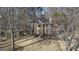 Traditional two story brick home nestled among mature trees with a well-maintained lawn at 302 Cumberland Ct, Peachtree City, GA 30269