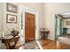 Inviting foyer with hardwood floors, a wooden front door, and natural light filtering through the sidelights at 302 Cumberland Ct, Peachtree City, GA 30269