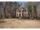 Charming two-story brick home featuring a classic design with well-maintained landscaping and mature trees surrounding the property at 302 Cumberland Ct, Peachtree City, GA 30269