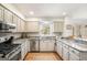 Spacious kitchen featuring granite countertops, stainless steel appliances, and ample cabinet space at 302 Cumberland Ct, Peachtree City, GA 30269