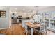 Bright kitchen featuring granite countertops, stainless steel appliances, and a wooden dining table at 302 Cumberland Ct, Peachtree City, GA 30269