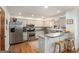 Well-equipped kitchen with stainless steel appliances, granite countertops, and wooden floors at 302 Cumberland Ct, Peachtree City, GA 30269