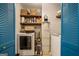 Organized laundry room with modern washer and dryer, shelving for storage, and ample space at 302 Cumberland Ct, Peachtree City, GA 30269