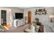 Comfortable living room featuring a TV, stylish furniture, and a view into an adjacent room at 302 Cumberland Ct, Peachtree City, GA 30269