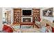 Inviting living room featuring a fireplace, built-in bookshelves, and a comfortable seating area with a colorful rug at 302 Cumberland Ct, Peachtree City, GA 30269