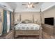 Elegant main bedroom with a four-poster bed, tray ceiling, and soft lighting, creating a peaceful and luxurious retreat at 302 Cumberland Ct, Peachtree City, GA 30269