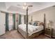 Comfortable main bedroom featuring a four-poster bed, soft drapes, and views from a large window at 302 Cumberland Ct, Peachtree City, GA 30269