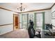 Bright office featuring natural light, neutral walls, and a view of the backyard through a window at 302 Cumberland Ct, Peachtree City, GA 30269