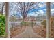 Brick-building community with a wrought-iron fence, patio, and mature landscaping at 498 N Jeff Davis Dr, Fayetteville, GA 30214