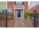 Attractive red brick townhome with welcoming front door and meticulously maintained landscaping at 498 N Jeff Davis Dr, Fayetteville, GA 30214