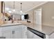 Bright kitchen with white cabinets, an island sink, and an adjacent dining area at 498 N Jeff Davis Dr, Fayetteville, GA 30214