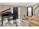 Cozy living room featuring a grand piano, front door access, and comfortable striped armchair at 498 N Jeff Davis Dr, Fayetteville, GA 30214