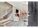 Inviting open-concept living room with stylish staircase and views into the modern kitchen at 498 N Jeff Davis Dr, Fayetteville, GA 30214