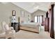 Vaulted main bedroom suite features a tufted headboard, accent furniture, and a cozy sitting area at 498 N Jeff Davis Dr, Fayetteville, GA 30214