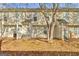 Backyard view showing multiple units, patios, privacy fences and mature trees at 1915 Grove Way, Hampton, GA 30228