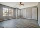 Sunlit bedroom featuring new flooring, and a ceiling fan at 1915 Grove Way, Hampton, GA 30228