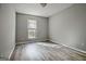 Bedroom featuring neutral gray paint and new flooring at 1915 Grove Way, Hampton, GA 30228