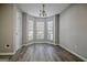 Spacious dining area with gray wood-look floors, a bay window, and neutral wall color at 1915 Grove Way, Hampton, GA 30228