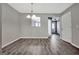Bright dining area featuring gray wood-look floors and a seamless flow to the rest of the home at 1915 Grove Way, Hampton, GA 30228