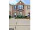 Beautiful brick townhouse featuring a bay window and well-maintained landscaping at 1915 Grove Way, Hampton, GA 30228