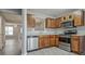 Well-equipped kitchen with stainless steel appliances, stylish wood cabinets, and ample counter space at 1915 Grove Way, Hampton, GA 30228