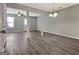 Open-concept living room boasts gray wood-look floors, and an airy atmosphere perfect for entertaining at 1915 Grove Way, Hampton, GA 30228