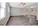 Bright open-concept living room featuring new flooring and a ceiling fan at 1915 Grove Way, Hampton, GA 30228