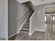 Gray staircase complemented by modern gray walls, leading to the upper level of the home at 1915 Grove Way, Hampton, GA 30228