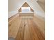 Attic bedroom featuring a wooden floor, a bed with white linens, and shiplap accent walls at 304 Chestatee Ct, Woodstock, GA 30188