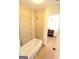 Bright bathroom featuring a tiled shower and tub combination, with hardwood floors at 304 Chestatee Ct, Woodstock, GA 30188