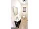 A well-lit bathroom with a toilet and vanity with a sink at 304 Chestatee Ct, Woodstock, GA 30188