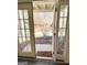 View through french doors onto a patio and wooded backyard at 304 Chestatee Ct, Woodstock, GA 30188