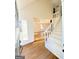 A white staircase next to a window as you enter this beautiful home at 304 Chestatee Ct, Woodstock, GA 30188