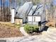 Charming two-story home with white siding, stone accents, and a welcoming front deck at 304 Chestatee Ct, Woodstock, GA 30188