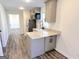 A well-lit kitchen showcasing gray cabinetry, granite countertops and stainless steel appliances at 304 Chestatee Ct, Woodstock, GA 30188